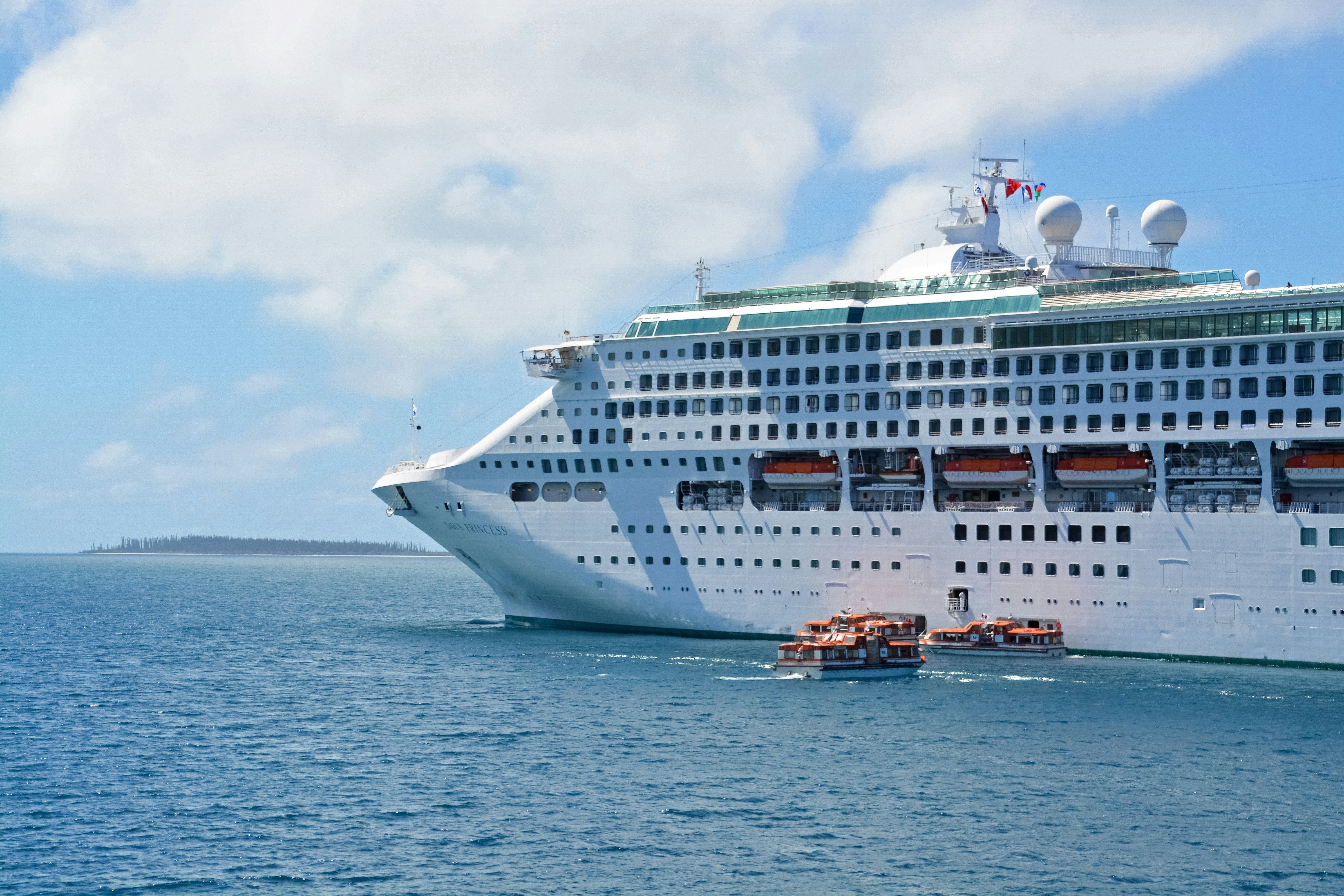 white cruise ship on sea under white clouds during daytime